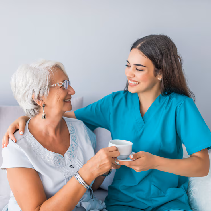 happy senior woman talking with friendly nurse geriatric ward 1391 2418 (1)